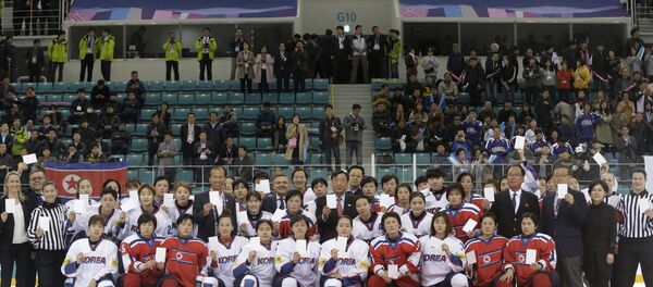 FILE - In this April 6, 2017, file photo, women's ice hockey players of South Korea, in white, and North Korea, in red, pose for a photo with International Ice Hockey Federation officials after their Ice Hockey Women's World Championship Division II Group A game in Gangneung, South Korea. North and South Korea agreed on Monday, Jan. 15, 2018, in principle to field a joint women's ice hockey team during next month's Olympics in South Korea, and relayed their position to the International Olympic Committee FILE - In this April 6, 2017, file photo, women's ice hockey players of South Korea, in white, and North Korea, in red, pose for a photo with International Ice Hockey Federation officials after their Ice Hockey Women's World Championship Division II Group A game in Gangneung, South Korea. North and South Korea agreed on Monday, Jan. 15, 2018, in principle to field a joint women's ice hockey team during next month's Olympics in South Korea, and relayed their position to the International Olympic Committee - Sputnik International