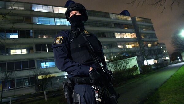 A policeman looks on after an object exploded next to a police station in Rosengard, Malmo, Sweden January 17, 2018 - Sputnik International