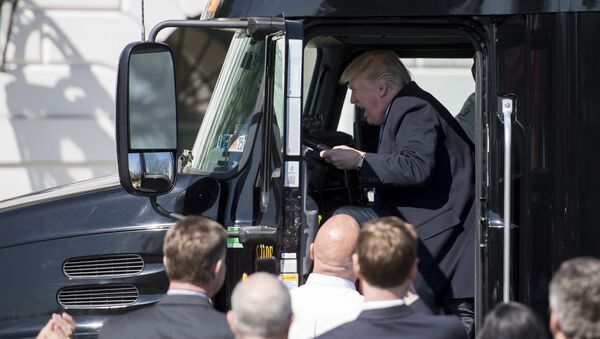 US President Donald Trump sits in the drivers seat of a semi-truck as he welcomes truckers and CEOs to the White House in Washington, DC, March 23, 2017, to discuss healthcare - Sputnik International