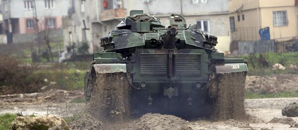 A Turkish army tank moves toward the Syrian border, in Reyhanlı, Turkey, Thursday, Jan. 18, 2018 A Turkish army tank moves toward the Syrian border, in Reyhanlı, Turkey, Thursday, Jan. 18, 2018 - Sputnik International