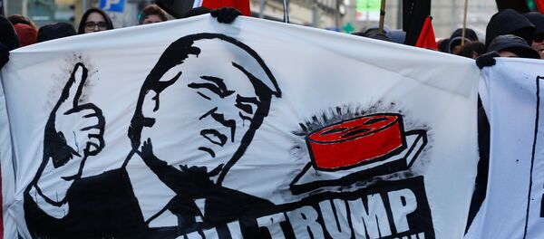 Protesters with banners march during an anti-WEF and anti-US President Donald Trump demonstration, ahead of Trump's visit to the World Economic Forum (WEF), in Bern, Switzerland, January 13, 2018. Protesters with banners march during an anti-WEF and anti-US President Donald Trump demonstration, ahead of Trump's visit to the World Economic Forum (WEF), in Bern, Switzerland, January 13, 2018. - Sputnik International