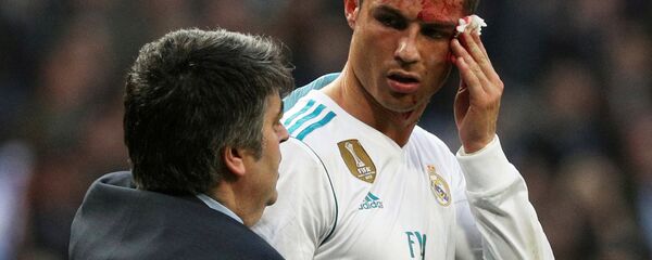 Soccer Football - La Liga Santander - Real Madrid vs Deportivo La Coruna - Santiago Bernabeu, Madrid, Spain - January 21, 2018 Real Madrid’s Cristiano Ronaldo receives treatment after sustaining an injury whilst scoring their sixth goal Soccer Football - La Liga Santander - Real Madrid vs Deportivo La Coruna - Santiago Bernabeu, Madrid, Spain - January 21, 2018 Real Madrid’s Cristiano Ronaldo receives treatment after sustaining an injury whilst scoring their sixth goal - Sputnik International