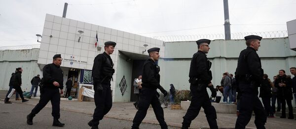 Riot police officers walk by Borgo prison on January 22, 2018 on the French Mediterranean Island of Corsica, as striking prison guards block its access as part of a nationwide movement to call for better safety and wages Riot police officers walk by Borgo prison on January 22, 2018 on the French Mediterranean Island of Corsica, as striking prison guards block its access as part of a nationwide movement to call for better safety and wages - Sputnik International
