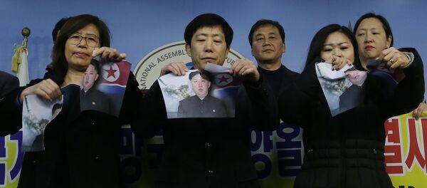 North Korean defectors tear portraits of North Korean leader Kim Jong Un during a press conference against the North Korea's participation in the 2018 Pyeongchang Winter Olympics at the National Assembly in Seoul, South Korea, Wednesday, Jan. 24, 2018 North Korean defectors tear portraits of North Korean leader Kim Jong Un during a press conference against the North Korea's participation in the 2018 Pyeongchang Winter Olympics at the National Assembly in Seoul, South Korea, Wednesday, Jan. 24, 2018 - Sputnik International