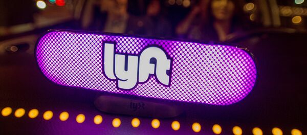 In this image distributed on Thursday, Feb. 9, 2017, Lyft's new Amp glows on the dashboard of a car in San Francisco. - Sputnik International