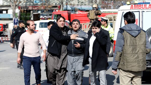 People assist an injured man after a blast in Kabul, Afghanistan January 27, 2018 - Sputnik International