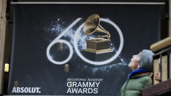 A young boy walks past advertisements promoting the 60th Annual Grammy Awards at the Madison Square Garden in New York on January 26, 2018 - Sputnik International