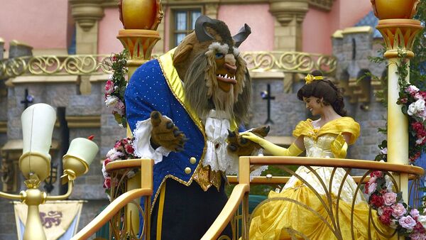 Disney characters from the movie Beauty and the Beast, Beast and Belle, dance during a parade along Main Street at Disneyland in Anaheim, Calif. Wednesday, May 4, 2005 - Sputnik International