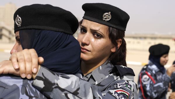 A newly graduated Iraqi police women sheds tears   during a graduation ceremony, at the Police College, Ministry of Interior Complex, in Baghdad - Sputnik International