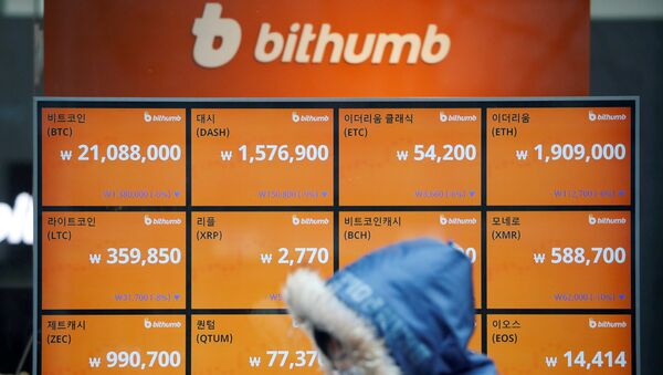 A man walks past an electric board showing exchange rates of various cryptocurrencies at Bithumb cryptocurrencies exchange in Seoul, South Korea, January 11, 2018 - Sputnik International
