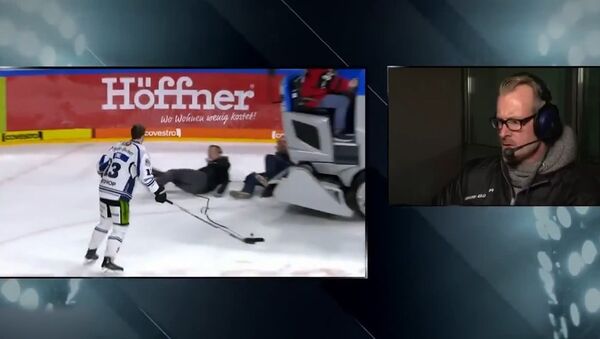 Screenshot of the dramatic moment a Zamboni backed into camera crew interviewing German hockey player Stefan Loibl. - Sputnik International