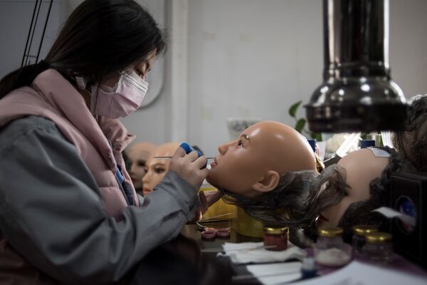 This photo taken on February 1, 2018 shows a worker painting the face of a silicone doll at a factory of EXDOLL, a firm based in the northeastern Chinese port city of Dalian - Sputnik International
