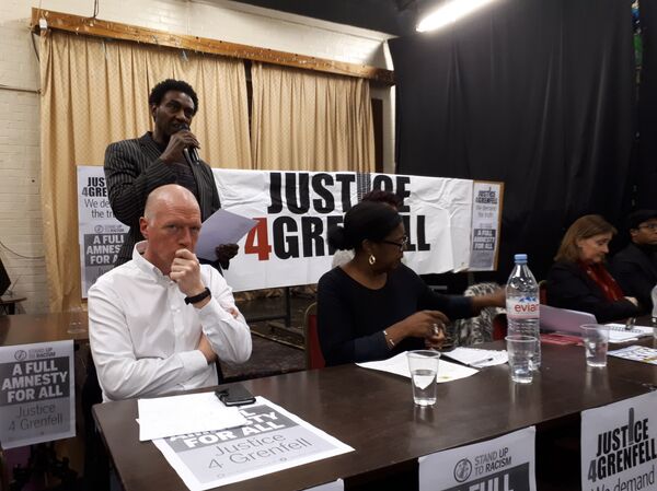 FBU leader Matt Wrack (seated, far left) listens as a resident reads out the names of the Grenfell Tower victims FBU leader Matt Wrack (seated, far left) listens as a resident reads out the names of the Grenfell Tower victims - Sputnik International