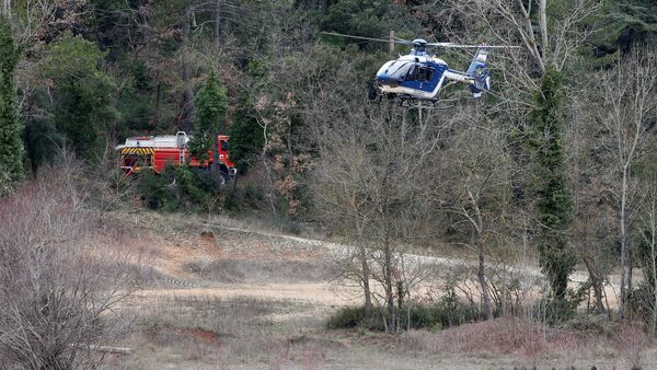 A helicopter from the French gendarmerie prepares to land near the site where two French military helicopters belonging to an army flight training school crashed killing five people near the Lac de Carces in the southeastern Var region, France, February 2, 2018 - Sputnik International