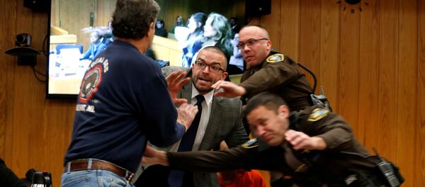 Randall Margraves (L) lunges at Larry Nassar (wearing orange) a former team USA Gymnastics doctor who pleaded guilty in November 2017 to sexual assault charges, during victim statements of his sentencing in the Eaton County Circuit Court in Charlotte, Michigan Randall Margraves (L) lunges at Larry Nassar (wearing orange) a former team USA Gymnastics doctor who pleaded guilty in November 2017 to sexual assault charges, during victim statements of his sentencing in the Eaton County Circuit Court in Charlotte, Michigan - Sputnik International