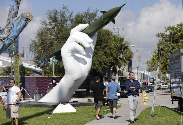 A sculpture titled Dangerous Game by Italian artist Lorenzo Quinn, right, is displayed in the Wynwood neighborhood of Miami, Friday, Dec. 8, 2017. The two-part installation shows a giant hand holding a nuclear missile as if it were a dart A sculpture titled Dangerous Game by Italian artist Lorenzo Quinn, right, is displayed in the Wynwood neighborhood of Miami, Friday, Dec. 8, 2017. The two-part installation shows a giant hand holding a nuclear missile as if it were a dart - Sputnik International