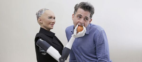 In this Sept. 28, 2017, photo, David Hanson, the founder of Hanson Robotics, poses with his company's flagship robot Sophia, a lifelike robot powered by artificial intelligence in Hong Kong In this Sept. 28, 2017, photo, David Hanson, the founder of Hanson Robotics, poses with his company's flagship robot Sophia, a lifelike robot powered by artificial intelligence in Hong Kong - Sputnik International