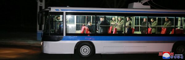 North Korean leader Kim Jong Un and his wife (seated R) are seen during the trial of a trackless tramway, February 4, 2018 - Sputnik International