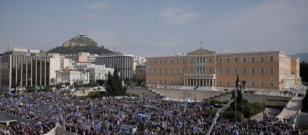 People are seen gathered outside the parliament building during a rally against the use of the term Macedonia in any settlement to a dispute between Athens and Skopje over the former Yugoslav republic's name, in Athens, Greece, February 4, 2018 - Sputnik International