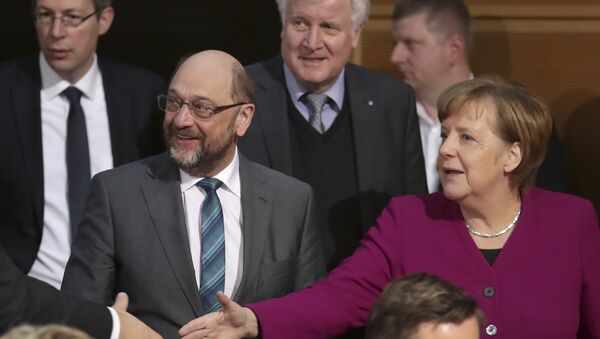 Martin Schulz, chairman of the German Social Democratic Party (SPD), front left, German Chancellor and chairwomen of the German Christian Democratic Union (CDU), Angela Merkel, front right, and Horst Seehofer, rear center, chairman of the Christian Social Union (CSU), arrive for coalition negotiations on a new German government between the Christian Unions bloc and the Social Democratic Party (SPD) in Berlin, Germany, Friday, Feb. 2, 2018. - Sputnik International