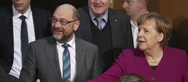 Martin Schulz, chairman of the German Social Democratic Party (SPD), front left, German Chancellor and chairwomen of the German Christian Democratic Union (CDU), Angela Merkel, front right, and Horst Seehofer, rear center, chairman of the Christian Social Union (CSU), arrive for coalition negotiations on a new German government between the Christian Unions bloc and the Social Democratic Party (SPD) in Berlin, Germany, Friday, Feb. 2, 2018. - Sputnik International