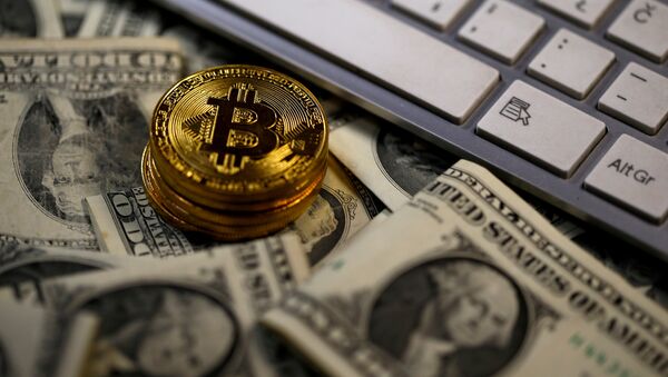 Bitcoin (virtual currency) coins placed on Dollar banknotes, next to computer keyboard, are seen in this illustration picture, November 6, 2017 - Sputnik International