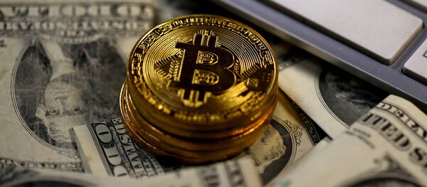 Bitcoin (virtual currency) coins placed on Dollar banknotes, next to computer keyboard, are seen in this illustration picture, November 6, 2017 Bitcoin (virtual currency) coins placed on Dollar banknotes, next to computer keyboard, are seen in this illustration picture, November 6, 2017 - Sputnik International