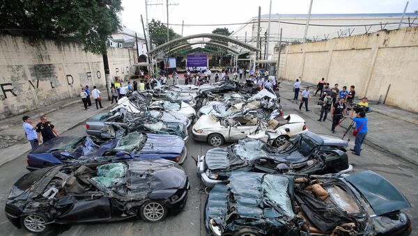 A bulldozer destroys condemned smuggled luxury cars worth 61,626,000.00 pesos (approximately US$1.2 million), which include used Lexus, BMW, Mercedes-Benz, Audi, Jaguar and Corvette Stingray, during the 116th Bureau of Customs founding anniversary in Metro Manila, Philippines February 6, 2018 - Sputnik International
