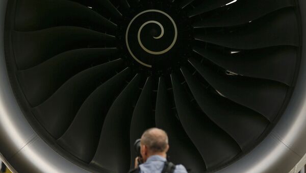 A visitor takes a photo of the Rolls-Royce jet engine of the Airbus A350-1000 parked at the static display area during the Singapore Airshow on Wednesday, Feb. 7, 2018, in Singapore. - Sputnik International