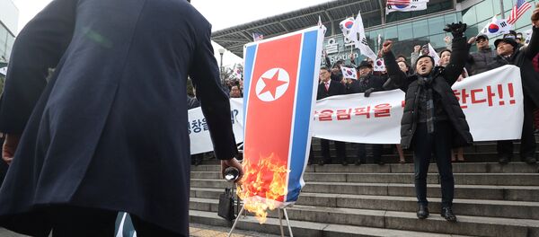 A member of a South Korean conservative civic group burns a North Korean national flag during a protest opposing North Korea's participation in the 2018 Pyeongchang Winter Olympics, in Seoul, South Korea, January 22, 2018 A member of a South Korean conservative civic group burns a North Korean national flag during a protest opposing North Korea's participation in the 2018 Pyeongchang Winter Olympics, in Seoul, South Korea, January 22, 2018 - Sputnik International