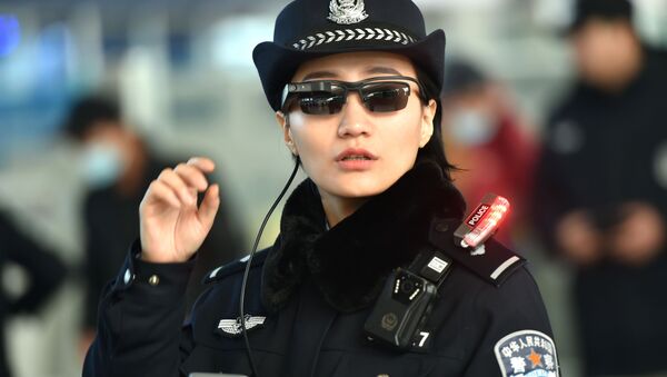 Police officer wearing a pair of smartglasses with a facial recognition system at Zhengzhou East Railway Station in Zhengzhou in China's central Henan province - Sputnik International
