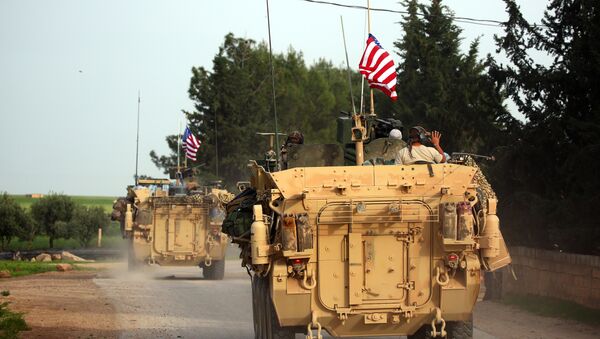 US forces, accompanied by Kurdish People's Protection Units (YPG) fighters, drive their armoured vehicles near the northern Syrian village of Darbasiyah, on the border with Turkey on April 28, 2017. (File) - Sputnik International