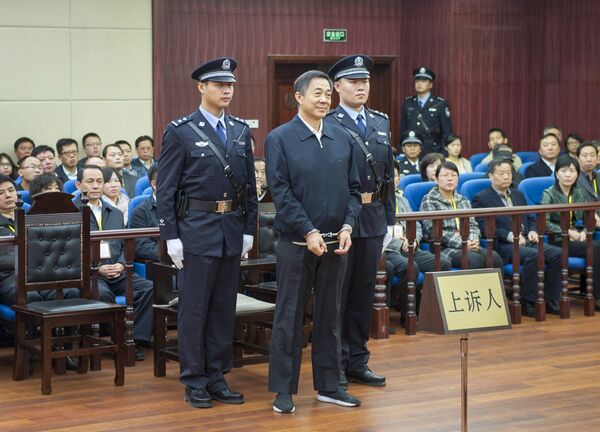 In this photo released by China's Xinhua News Agency, ousted Chinese politician Bo Xilai, center, stands as the Shandong Provincial Higher People's Court announces the decision of the second trial of Bo, in Jinan, China's Shandong Province In this photo released by China's Xinhua News Agency, ousted Chinese politician Bo Xilai, center, stands as the Shandong Provincial Higher People's Court announces the decision of the second trial of Bo, in Jinan, China's Shandong Province - Sputnik International