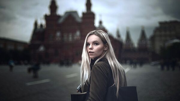 A young woman walking on the Red Square in Moscow A young woman walking on the Red Square in Moscow - Sputnik International