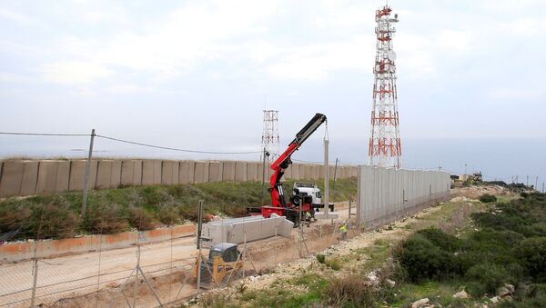Israeli workers are seen building a wall near the border with Israel near the village of Naqoura, Lebanon February 8, 2018 - Sputnik International