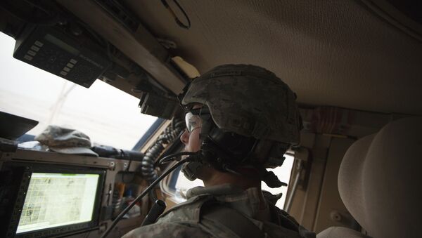 In Dec. 16, 2011 photo, Sergeant Daniel Martin watches the road and a GPS device inside his unit's Mine Resistant Ambush Protected vehicle during the US military's last combat patrol in Iraq - Sputnik International