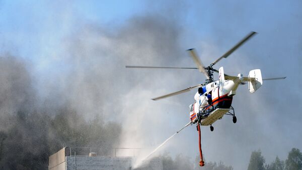 A Ka-32A helicopter putting fire out using a fire gun. An inter-departmental demonstration field exercise held as part of the 3rd Integrated Safety and Security 2010 International Exhibition. (File) - Sputnik International