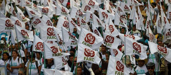 FARC members and supporters wave flags with the new logo of the rebaptized FARC (Common Alternative Revolutionary Force), transformed into a political party following its disarmament, during the closing of their National Congress in Bogota. (File) FARC members and supporters wave flags with the new logo of the rebaptized FARC (Common Alternative Revolutionary Force), transformed into a political party following its disarmament, during the closing of their National Congress in Bogota. (File) - Sputnik International