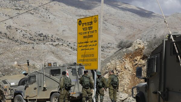 Israeli soldiers stand guard near the Israeli Syrian border next to the town of Majdal Shams in the Israeli-occupied sector of the Golan Heights - Sputnik International