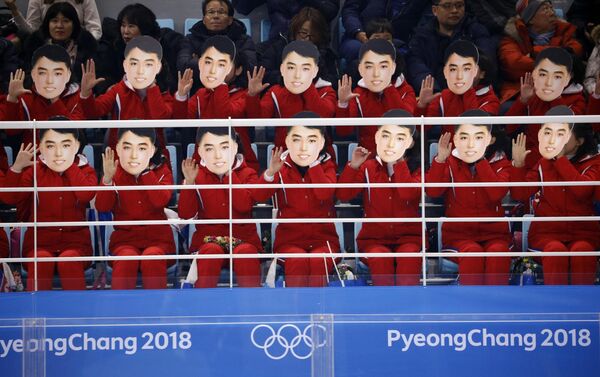Ice Hockey – Pyeongchang 2018 Winter Olympics – Women Preliminary Round Match - Switzerland v Korea - Kwandong Hockey Centre, Gangneung, South Korea – February 10, 2018 - North Korea's cheer squad hold masks Ice Hockey – Pyeongchang 2018 Winter Olympics – Women Preliminary Round Match - Switzerland v Korea - Kwandong Hockey Centre, Gangneung, South Korea – February 10, 2018 - North Korea's cheer squad hold masks - Sputnik International