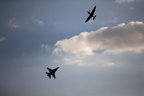 An Israeli Air Force F-16 plane, bottom, and an Israeli Air force Spitfire plane perform during a graduation ceremony for new pilots in the Hatzerim air force base near the city of Beersheba, Israel. (File) An Israeli Air Force F-16 plane, bottom, and an Israeli Air force Spitfire plane perform during a graduation ceremony for new pilots in the Hatzerim air force base near the city of Beersheba, Israel. (File) - Sputnik International