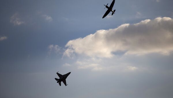 An Israeli Air Force F-16 plane, bottom, and an Israeli Air force Spitfire plane perform during a graduation ceremony for new pilots in the Hatzerim air force base near the city of Beersheba, Israel. (File) - Sputnik International