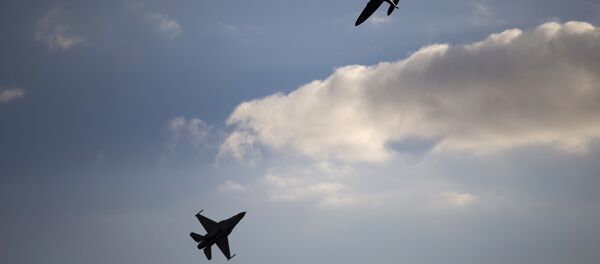 An Israeli Air Force F-16 plane, bottom, and an Israeli Air force Spitfire plane perform during a graduation ceremony for new pilots in the Hatzerim air force base near the city of Beersheba, Israel. (File) - Sputnik International