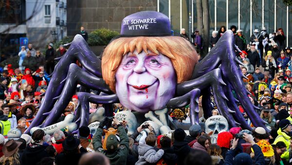 A carnival float shows Christian Democratic Union (CDU) leader and German Chancellor Angela Merkel as black widow at the traditional Rosenmontag Rose Monday carnival parade in Duesseldorf, Germany, February 12, 2018 - Sputnik International