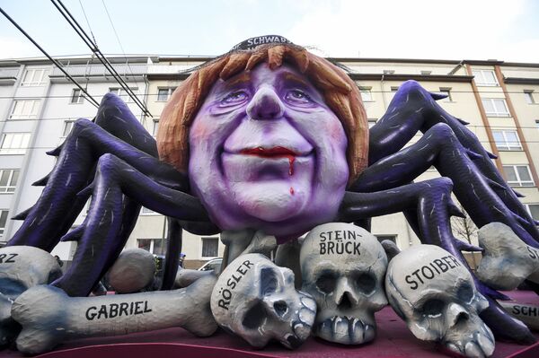 A carnival float depicting German chancellor Angela Merkel as a black widow sitting over the bones and sculls of German politicians is pictured during a carnival parade on Rose Monday on February 12, 2018 in Duesseldorf, western Germany - Sputnik International