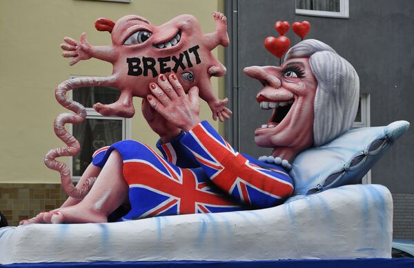 A float depicts British Prime Minister Theresa May looking at her Brexit-baby during the traditional Rose Monday parade in Duesseldorf, Germany A float depicts British Prime Minister Theresa May looking at her Brexit-baby during the traditional Rose Monday parade in Duesseldorf, Germany - Sputnik International