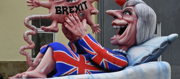 A float depicts British Prime Minister Theresa May looking at her Brexit-baby during the traditional Rose Monday parade in Duesseldorf, Germany A float depicts British Prime Minister Theresa May looking at her Brexit-baby during the traditional Rose Monday parade in Duesseldorf, Germany - Sputnik International