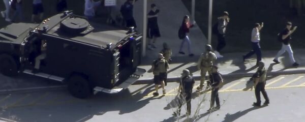 In this frame grab from video provided by WPLG-TV, students from the Marjory Stoneman Douglas High School in Parkland, Fla., evacuate the school following a shooting, Wednesday, Feb. 14, 2018. In this frame grab from video provided by WPLG-TV, students from the Marjory Stoneman Douglas High School in Parkland, Fla., evacuate the school following a shooting, Wednesday, Feb. 14, 2018. - Sputnik International