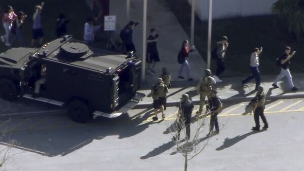 In this frame grab from video provided by WPLG-TV, students from the Marjory Stoneman Douglas High School in Parkland, Fla., evacuate the school following a shooting, Wednesday, Feb. 14, 2018. - Sputnik International