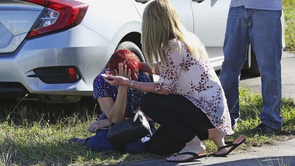 A woman consoles another as parents wait for news regarding a shooting at Marjory Stoneman Douglas High School in Parkland, Fla., Wednesday, Feb. 14, 2018. - Sputnik International